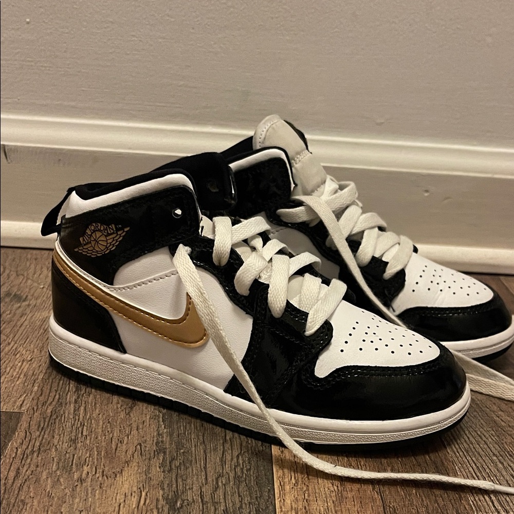 Nike Black and Gold High-Top Jordan’s